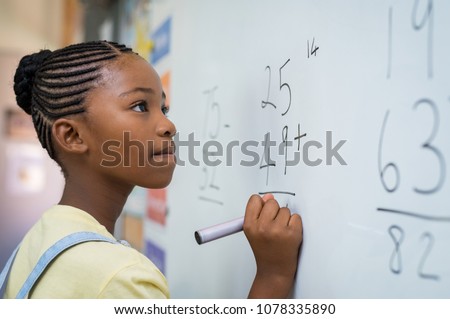 Similar – Foto Bild Schwarzes Mädchen schreibt auf Tafel im Klassenzimmer