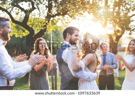 Bride and groom dancing at wedding reception outside in the backyard. Сток-фото © 