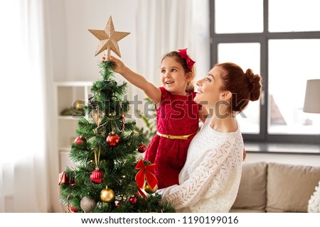 Similar – Image, Stock Photo Child decorating the tree seen from behind