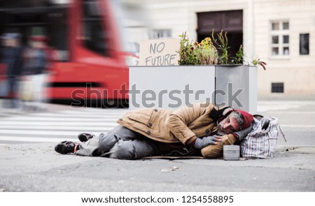 Similar – Foto Bild ein Obdachloser schläft im Eingang eines Plattenbaus in Berlin Mitte