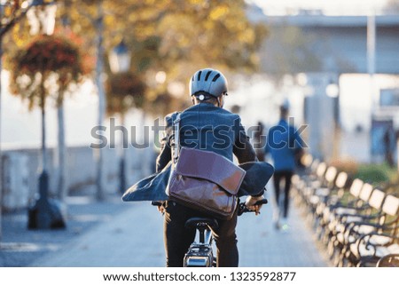 Similar – Image, Stock Photo Cyclist riding bike on rural road in highlands