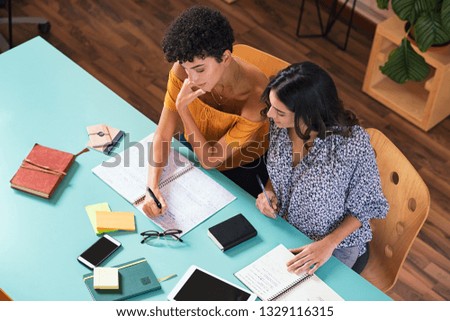 Similar – Image, Stock Photo Ethnic woman taking notes in notebook at home