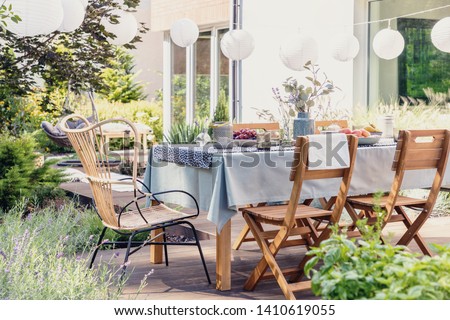 Similar – Image, Stock Photo set garden table with fairy lights in play of light and shadow