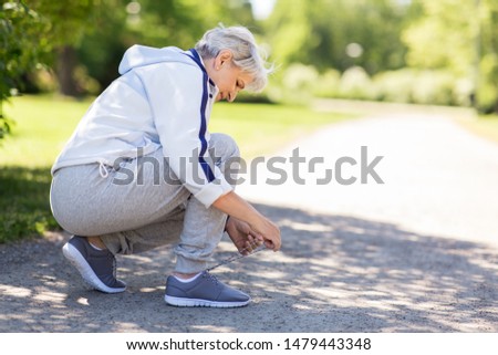 Similar – Image, Stock Photo Sporty woman tying laces on sneakers before training