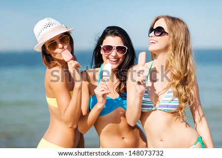vacaciones y vacaciones de verano - chicas en bikini con helado en la playa