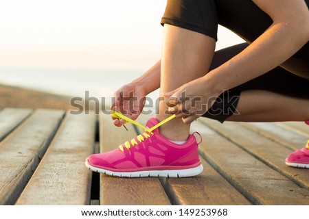 Similar – Image, Stock Photo Sporty woman tying laces on sneakers before training