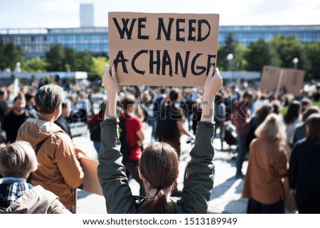 Rear view of people with placards and posters on global strike for climate change. Stockfoto © 