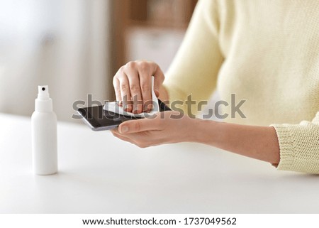 Image, Stock Photo Woman disinfecting phone with antiseptic wet wipe. Antiseptic napkin to prevent spread of germs, bacteria and coronavirus. Coronavirus prevention. Prevent illness coronavirus after public place.