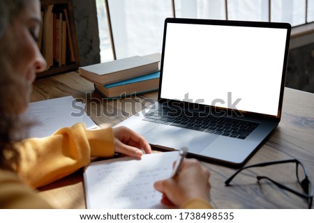 Similar – Image, Stock Photo Looking over the shoulder of a young woman with glasses working on a notebook at home. Home office. Online lecture. Homeschooling.