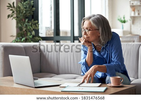 Senior mature older woman watching business training, online webinar on laptop computer remote working or social distance learning from home. 60s businesswoman video conference calling in virtual chat Foto d'archivio © 