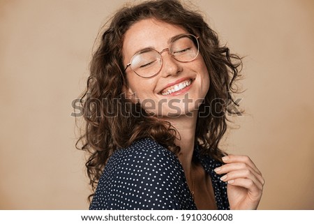 Similar – Image, Stock Photo Young woman with big smile smiling to camera with color background and copy space. Happy and fun attitude, mental health and taking care of herself concept. Be happy, smile, white teeth.