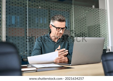 Mature business man executive coach talking using laptop computer having video conference call virtual meeting, professional training negotiation remote working doing online presentation in office. Foto stock © 
