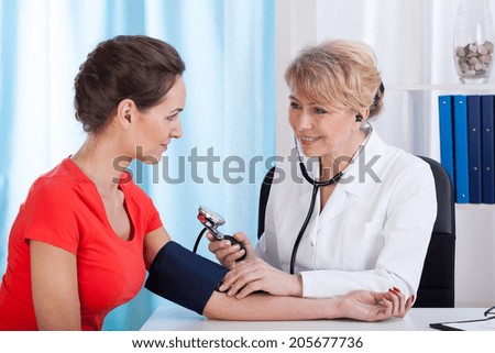 Image, Stock Photo Doctor measuring blood pressure of female patient in hospital office. Sick senior woman having a doctor appointment. Close up