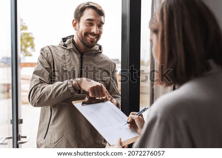 population census, polling and people concept - male social worker asking woman sign papers on clipboard at home Stockfoto © 