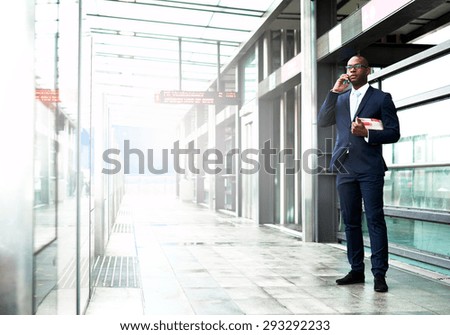 Similar – Image, Stock Photo Stylish black businessman chatting on smartphone against building wall