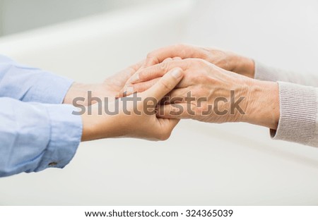 Similar – Man holding an elderly woman’s hand