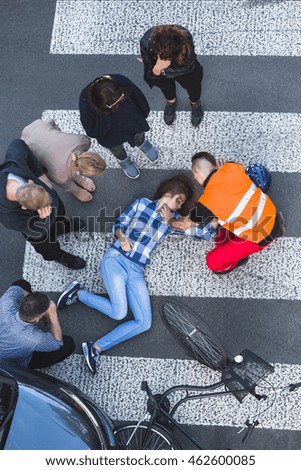Onlookers of car crash surrounded the accident casualty lying on the road  Stock fotó © 