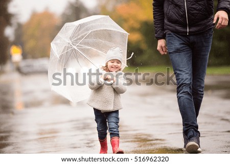 Similar – Image, Stock Photo Cute child under umbrella on rainy day in autumn park