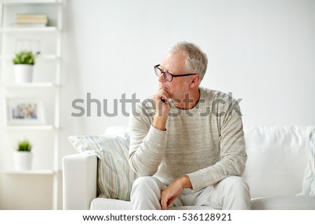 Similar – Image, Stock Photo Pensive senior male sitting on floor with cup of tea
