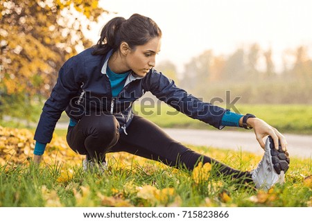 Similar – Woman stretching after running