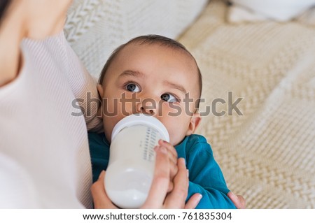 Image, Stock Photo Mother bottle feeding newborn