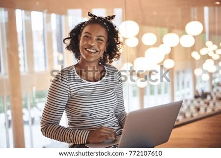 Similar – Image, Stock Photo The young woman in the blue sweater sits comfortably in the armchair and holds a coffee mug and a book in her hands. Upper body portrait without head