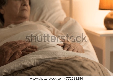 Close-up of a person supporting a sick, bedridden family member at home Foto stock © 