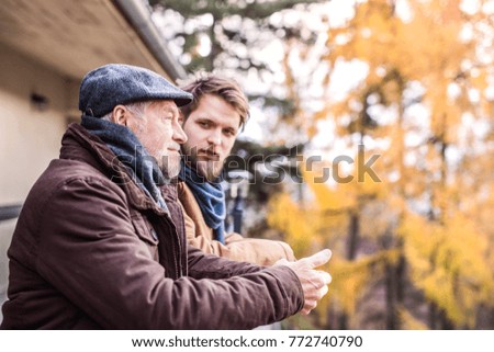 Similar – Image, Stock Photo Grandfather talking to his grandchildren and relatives, who were quarantined from home, about the coronavirus. Elderly man using smartphone and tablet in his office