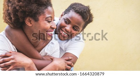 Similar – Image, Stock Photo Son hugging his mom and kissing her on the cheek