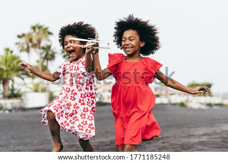 Similar – Image, Stock Photo Two children playing with their mobile on the beach