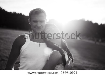 slender young happy couple sports girl and man on a picnic in the park