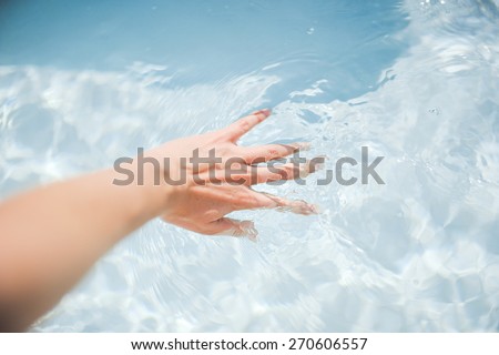 girl\'s hand in the water clean
