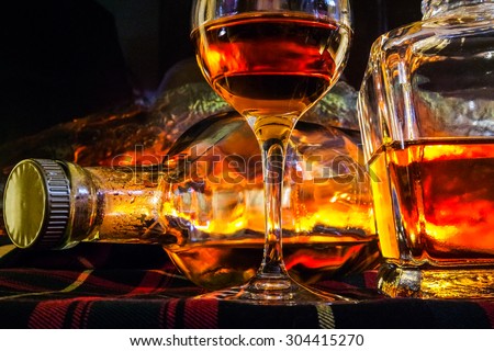 Alcoholic drink background with open fire . Whisky, whiskey, brandy, cognac, liqueur