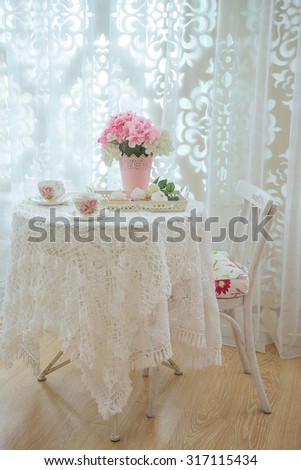 beautifully covered table and chair, there is not a body