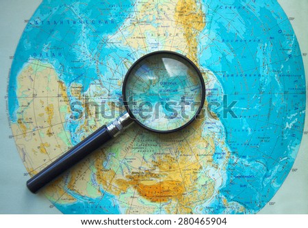 KALININGRAD, RUSSIA - JUNE 28, 2008: Magnifying glass lies on the map of the Northern hemisphere