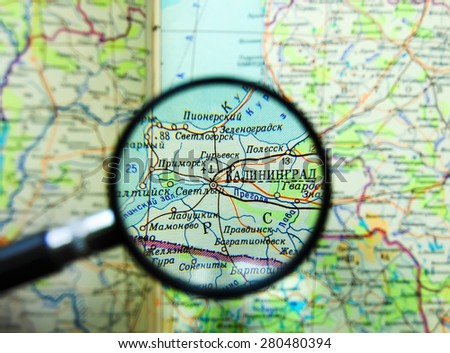 KALININGRAD, RUSSIA - JUNE 28, 2008: Magnifying glass lies on the map. The city of Kaliningrad is seen in focus