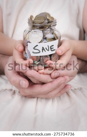 Family Hands holding a money jar of australian money \