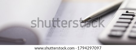 Close-up of accounting tools lying on statement. Employee using special equipments. Accountant balancing monthly balance. Finance and business concept