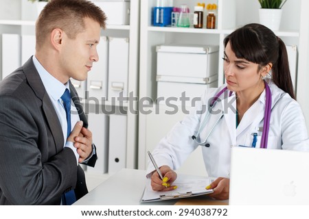 Concerned beautiful female medicine doctor listening carefully patient complaints. Medical care or insurance concept. Physician ready to examine patient and help. Cardiology and heart health concept
