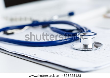 Medical stethoscope lying on cardiogram chart closeup. Medical help, prophylaxis, disease prevention or insurance concept. Cardiology care,health, protection and prevention. Healthy life concept