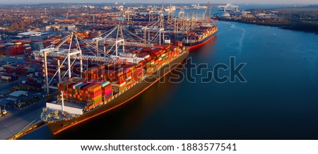 Banner - Aerial view of colorful containers on cargo ships at the port of Southampton, which is one of the Leading Port Terminal Operators in the UK. Space for text.