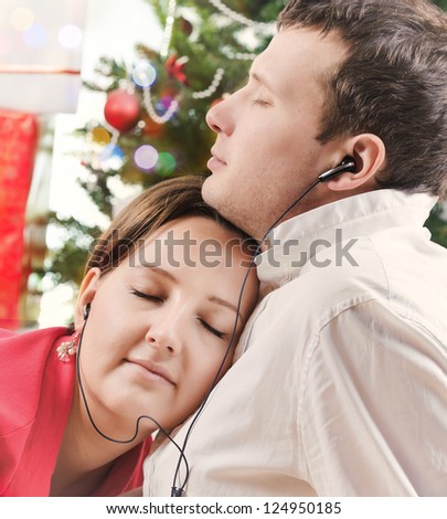 Happy couple listening music in headset together