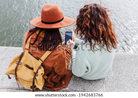 Similar – Image, Stock Photo two women sightseeing Porto views by the river and taking picture with mobile phone. Travel and friendship concept