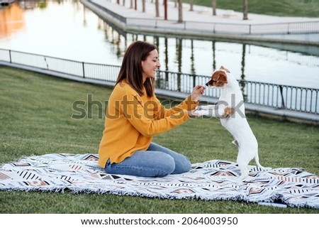 Similar – Image, Stock Photo Owner giving food to dog