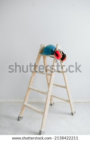 Similar – Foto Bild Leiter, blauer Schutzhelm und Ohrenschützer auf der Baustelle. Heimwerken, Renovierung