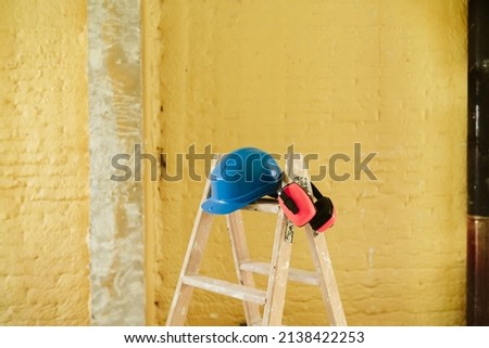 Similar – Foto Bild Leiter, blauer Schutzhelm und Ohrenschützer auf der Baustelle. Heimwerken, Renovierung