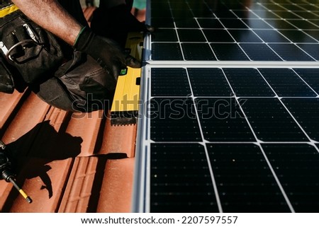 Similar – Foto Bild Hand von reifen Techniker Mann Montage von Sonnenkollektoren mit Bohrer auf Hausdach für Selbstverbrauch Energie. Erneuerbare Energien und grünes Energiekonzept