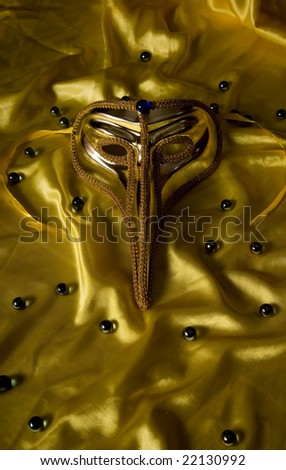 Beautiful carnival mask over yellow silk
