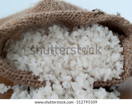 Sea salt or sea salt, put in a sack and put on the wooden floor.