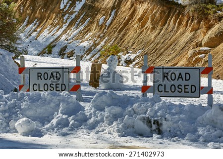 Road closed, mountains, snowman with sign, national park, USA